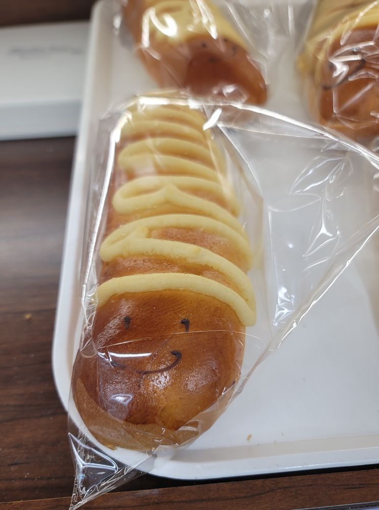 Its a snake shaped custard bun with a smile drawn onto it...