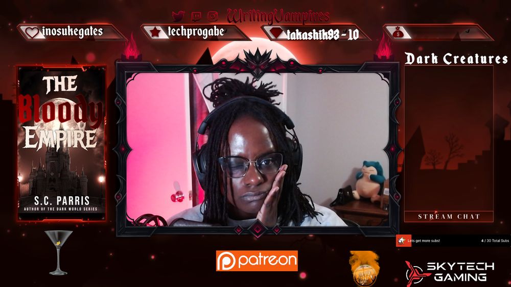 screenshot of writingvampire's stream overlay with her in the webcam holding her face cheek with her hand