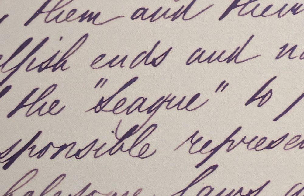Detail of cursive script letter. one word stands out. "League".