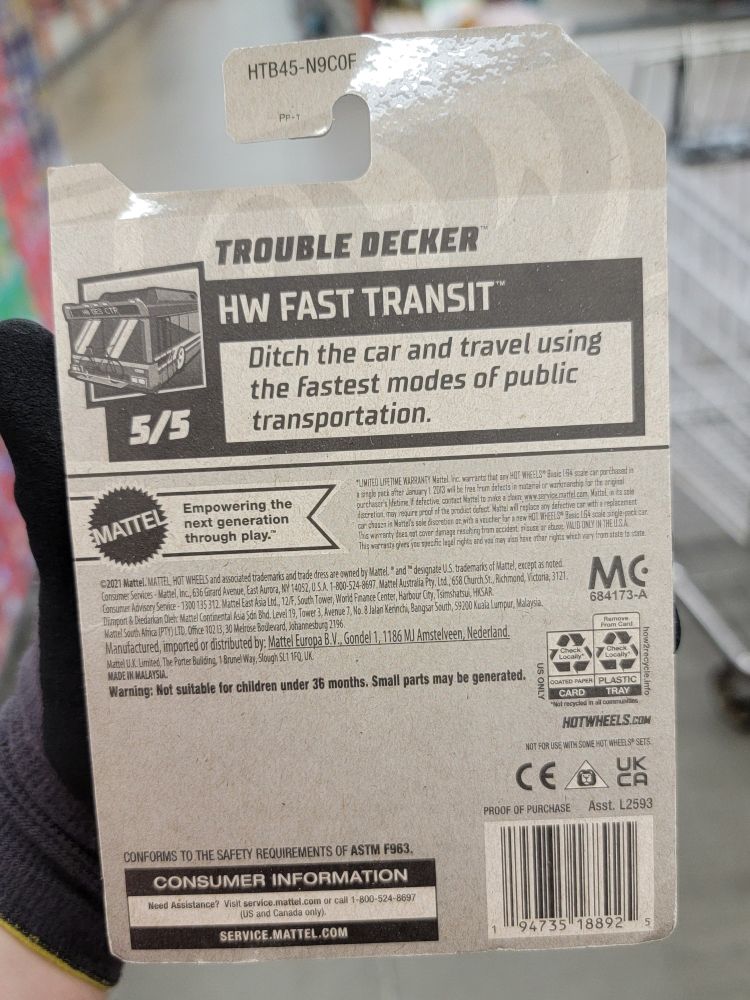 The back of the package of a Hot Wheels bus. The back says "Trouble Decker, HW Fast Transit. Ditch the car and travel using the fastest modes of public transportation." 