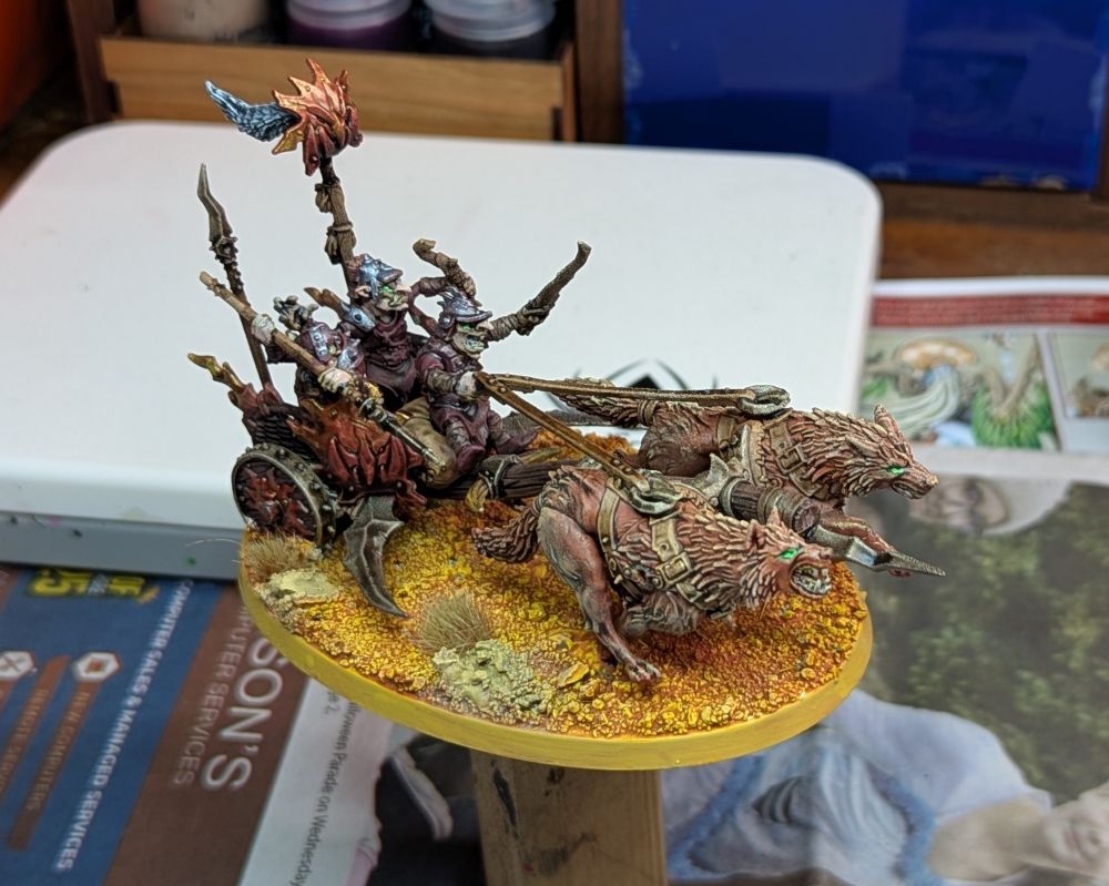 A Warhammer miniature. Three goblins on a chariot. 