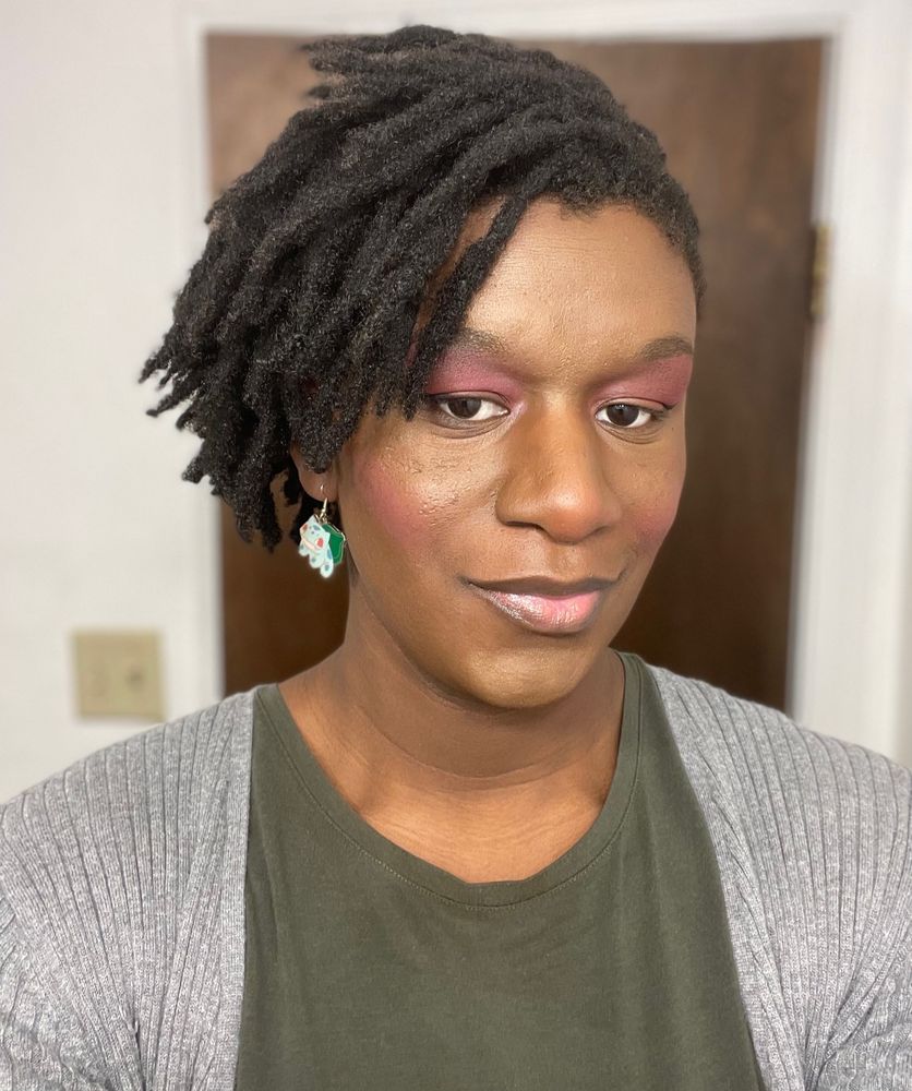 Maya in blush contour, highlight and eyeshadow with bulbasaur earrings.