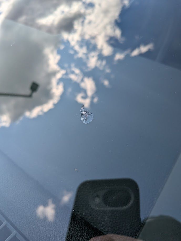 Dime sized chip in car windshield from road debris.