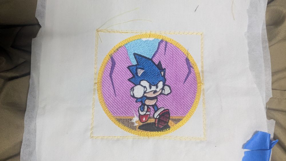 Embroidery of Sonic the hedgehog running. Embroidery done on white pillow cloth using a Brother ULT2001