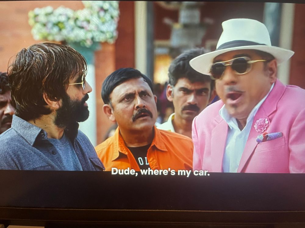 Screenshot from a bollywood movie that i will not name bc it’s embarrassing that im watching it where an extravagantly dressed man is saying “dude, wheres my car” 