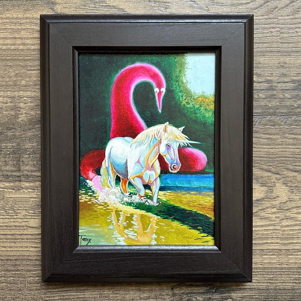 An original oil painting of a serene forest landscape that depicts a white unicorn walking through calm water, splashing its legs. Behind the unicorn, a large pink fluffy worm on a tring dominates the background. The worm features googly eyes, adding a whimsical touch to the scene.
