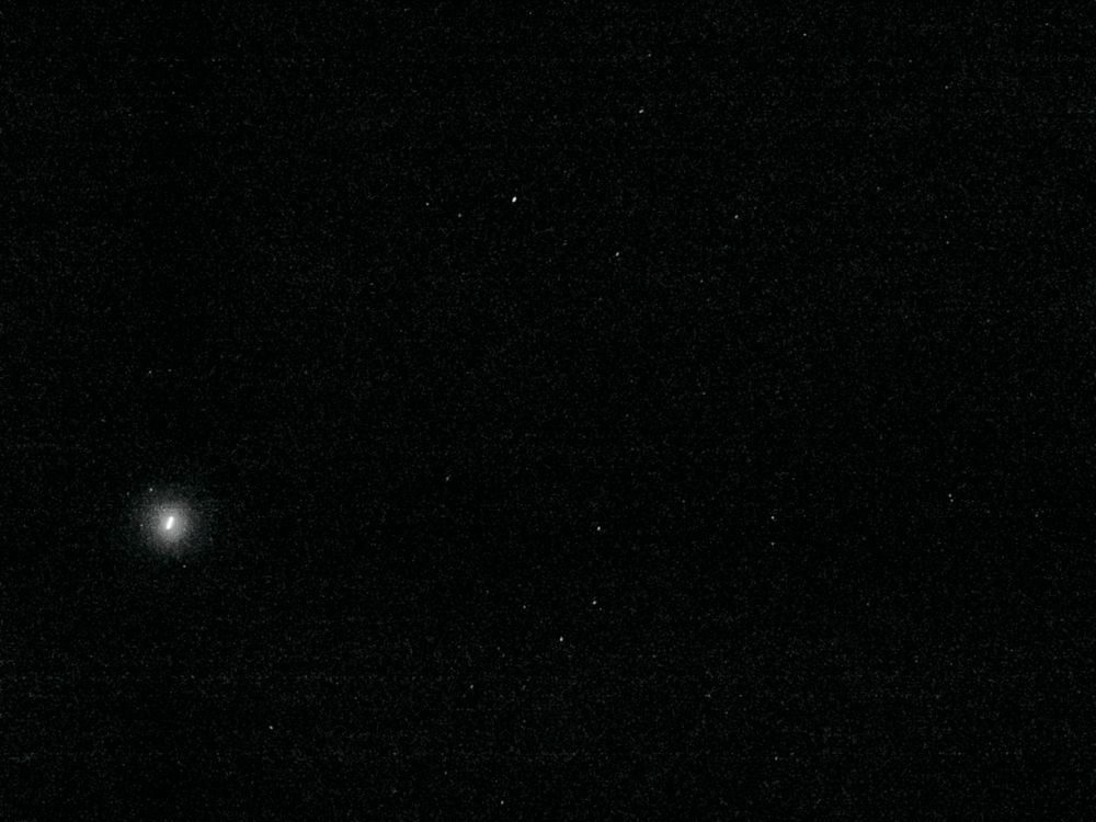 Processed version of the Perseverance Navcam image from Sol 1643 with all the noise removed. It shows a much larger area of sky than the infamous raw image because it was stitched from 16 individual tiles which are sent separately. 
It shows a dark sky with a couple of stars sprinkled around. The brightest is Arcturus at the top center, and the handle of the big dipper can be seen below. On the left is a bright streak with a halo, this is the moon Phobos. 