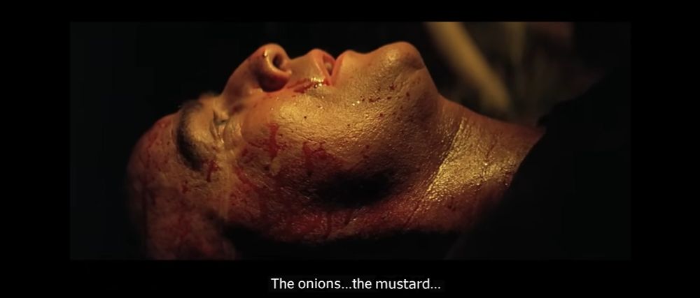 Colonel Kurtz from Apocalypse Now lies on his back, blood-spattered, whispering, "The onions... the mustard..."