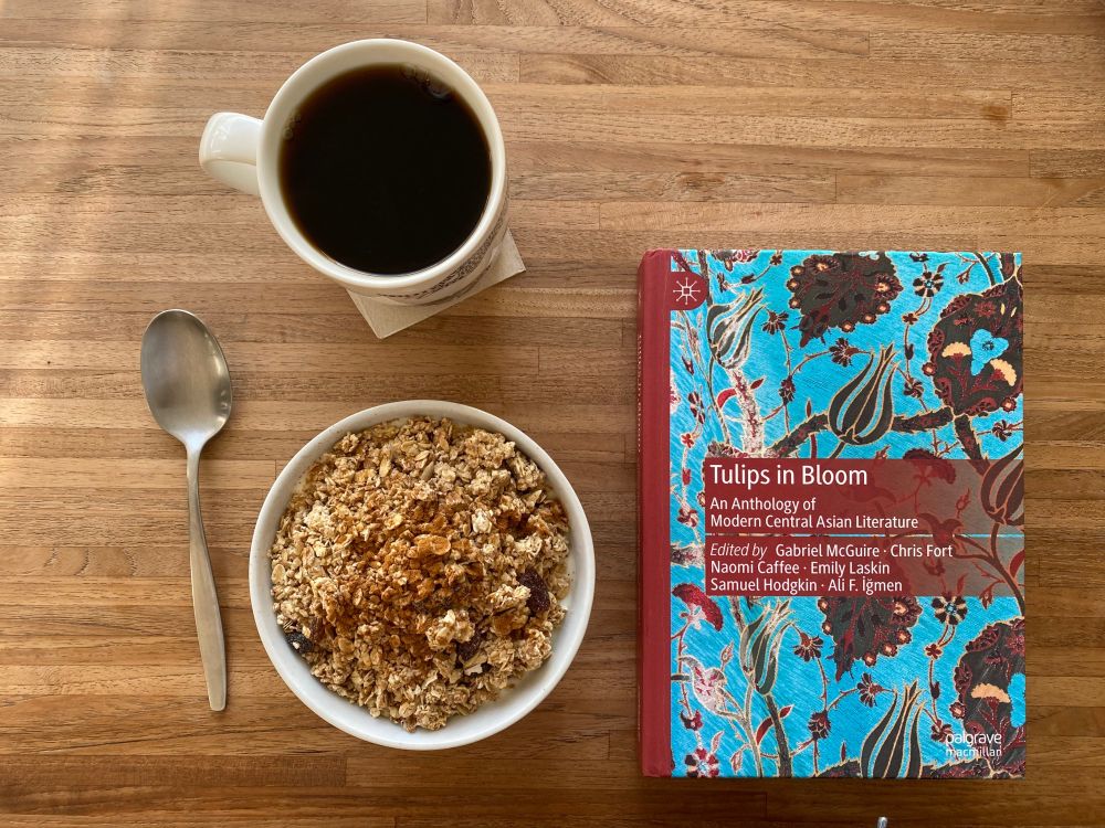 my breakfast and a lovely turquoise and red book titled “tulips in bloom: an anthology of modern central asian literature”