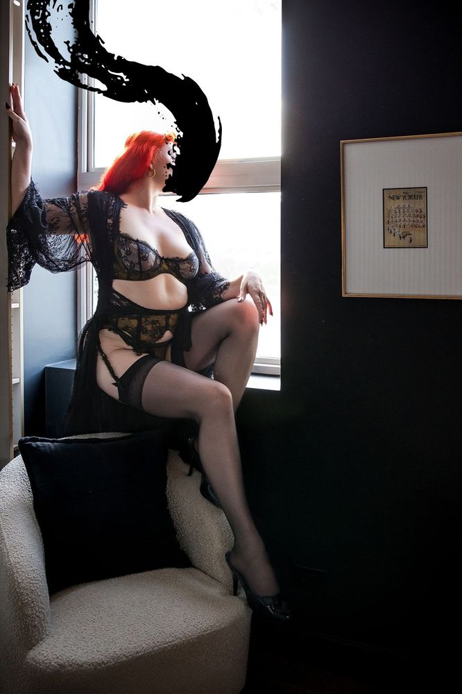 Wearing gorgeous lingerie and hosiery, June is perched upon a windowsill enjoying the city view. An armchair sits empty at her feet and a New Yorker artwork decorates the wall. Photography by Jill Kerswill.