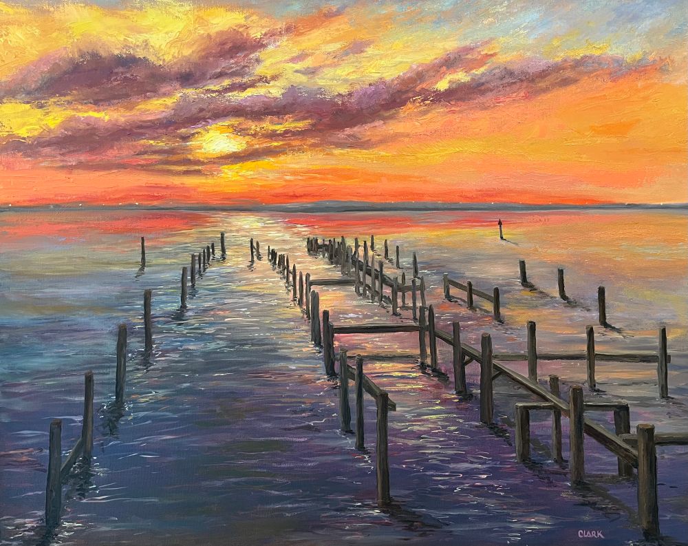 Sunset view across the bay showing the broken piers after storms have taken their toll.  Done in a multitude of colors, but full of orange yellows and purple.  I common sight along the Gulf Coast.