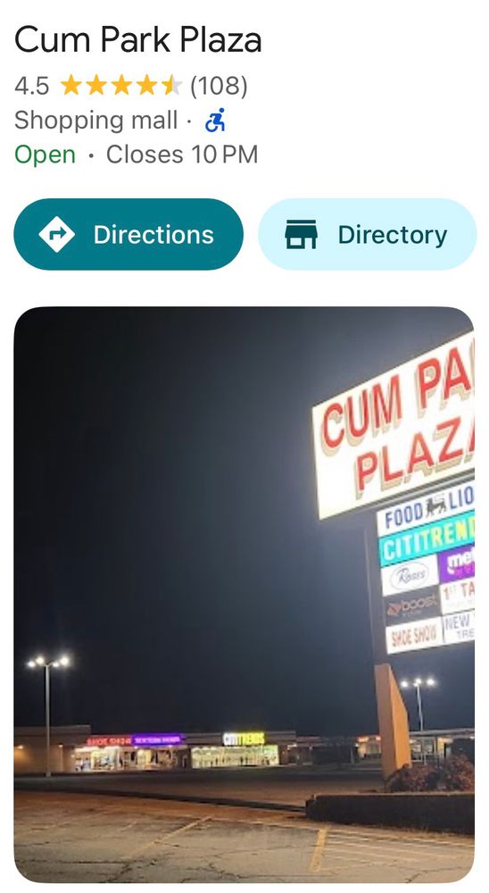 Sign and parking lot of the family friendly Cum Park Plaza.