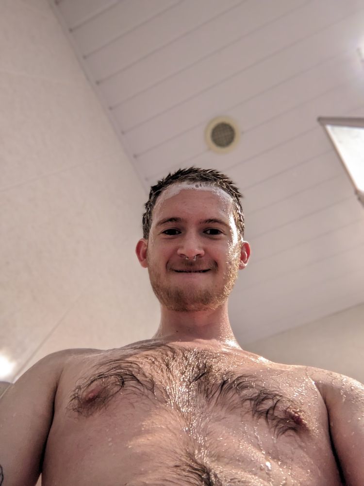 Wet man with hairy chest, taken from a downward angle
