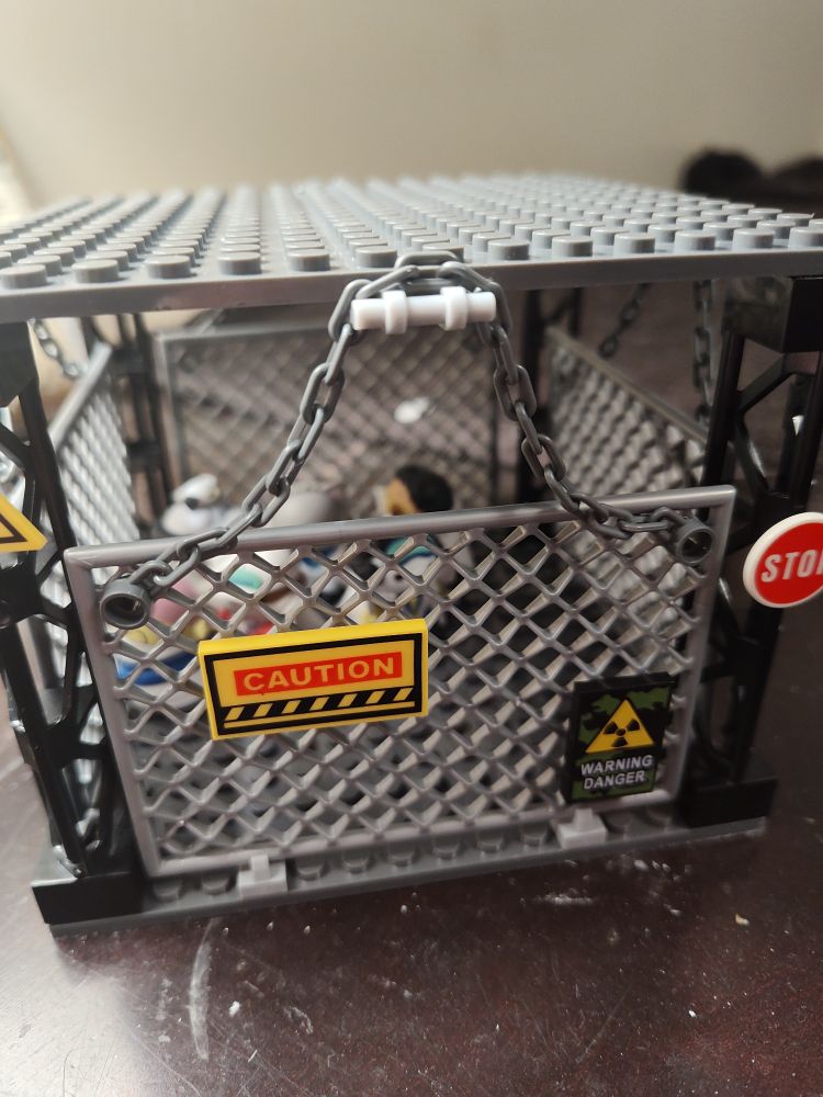 A toy cage with cat-themed One Piece toys inside. Fuck you, Garp.