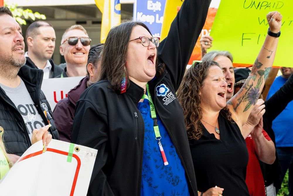 CUPE BC President Karen Ranalletta and Sussanne, fists raised and chanting