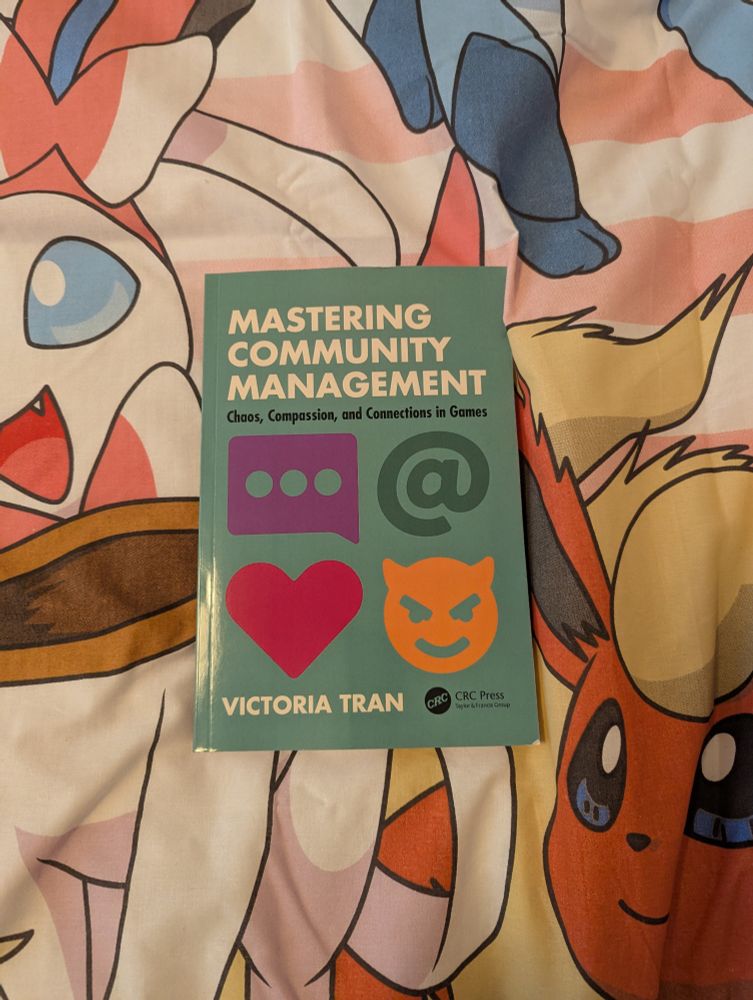 Mastering Community Management, a book by Victoria Tran, on Eeveelution bedsheets.