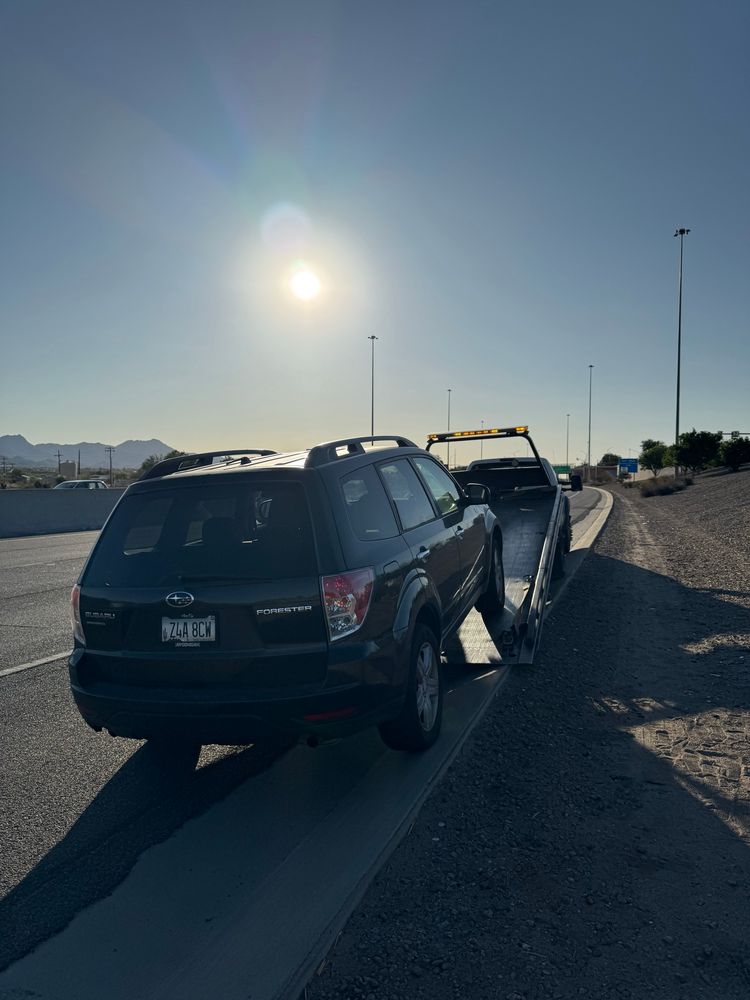 Photo of a Subaru Forester being pulled onto a flatbed. 