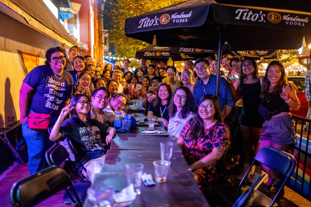A group of almost 50 LGBTQ+ AAPI journalists smiling and having fun 