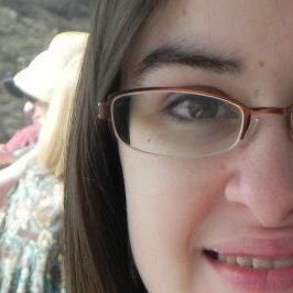Artistically cropped half-face profile photo of me from what I believe is pre-2014. Half-frame metal glasses, half-convincing smile, probay half an idea of what is going on. I like my eyebrows tho.