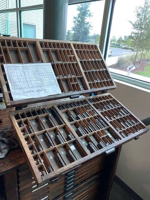 A typesetting case in two parts, upper and lower, it’s a big wooden hinged rack full of little metal letters
