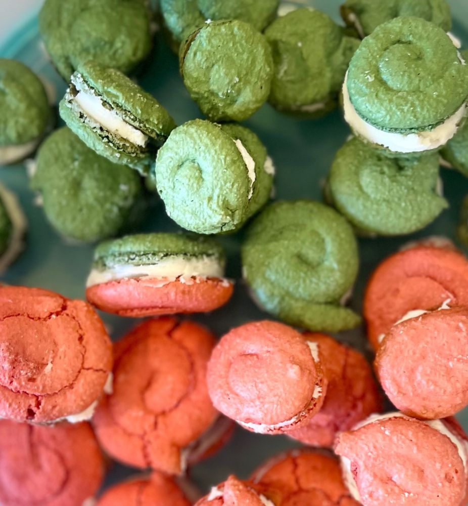 Green and red macarons with vanilla royal icing. 