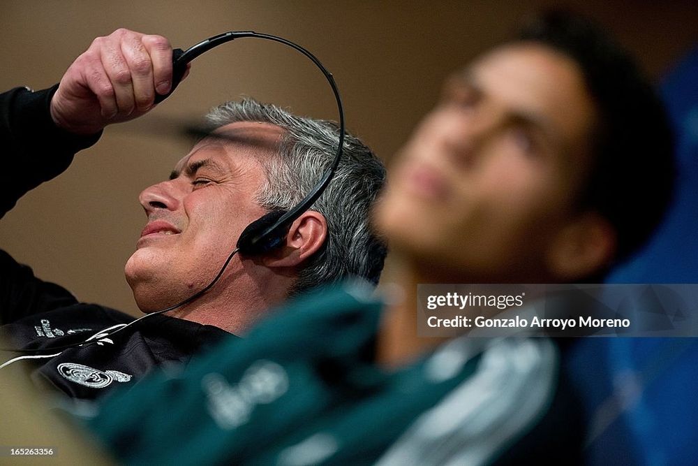 Head coach Jose Mourinho takes off his headphones annoyed while Real Madrid player Raphael Varane listen to questions from the media during a press conference ahead of the UEFA Champions League Quarterfinal match between Real Madrid and Galatasaray AS at Santiago Bernabeu Stadium on April 2, 2013 in Madrid, Spain. (Photo by Gonzalo Arroyo Moreno/Getty Images)