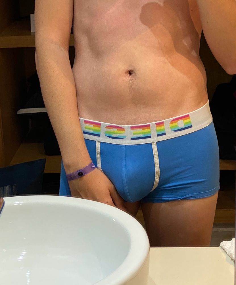 A picture of me wearing blue Diesel boxerbriefs and nothing else. My bulge is visible