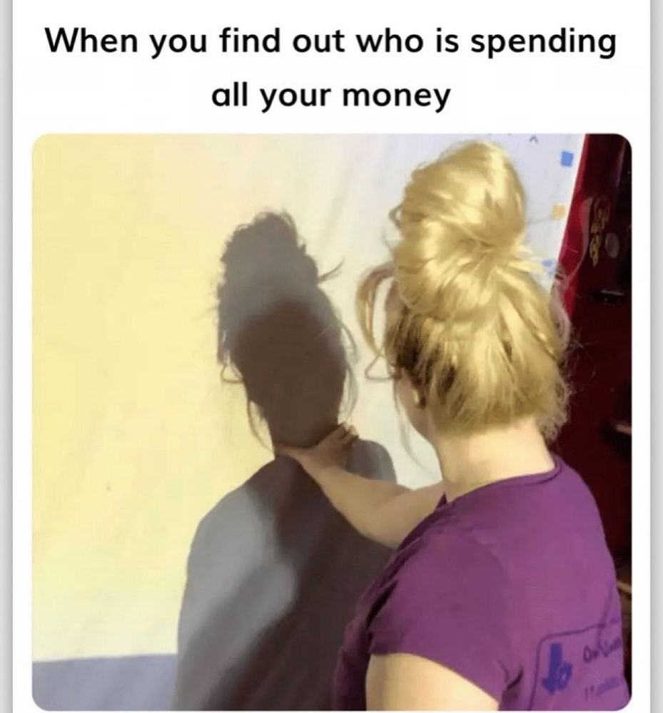 Woman facing a wall and “strangling” her own shadow.
