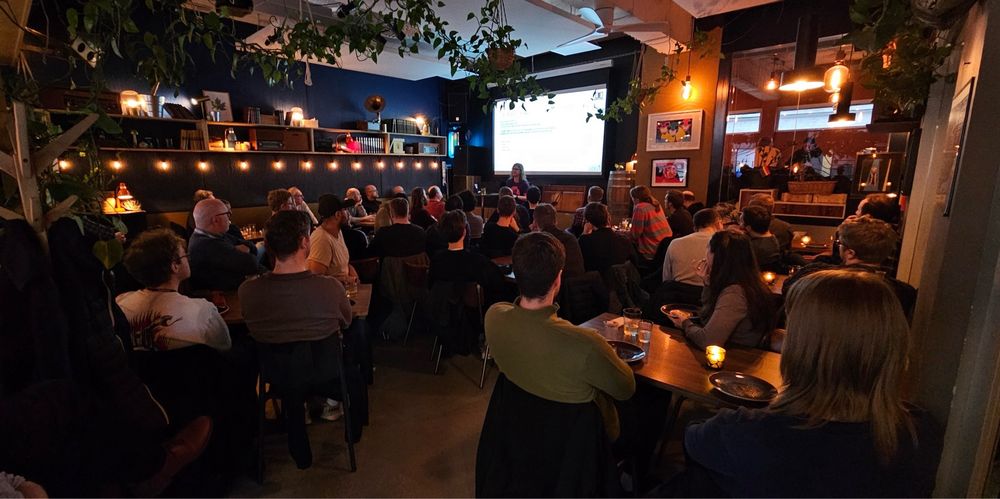 A room full of people looking at a presentation 