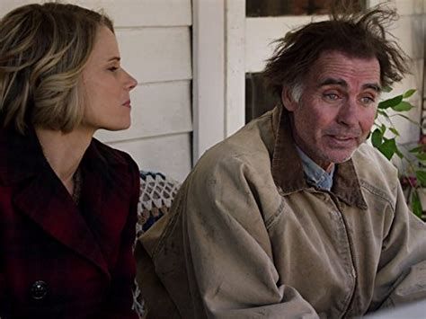 Young blonde short haired lady in profile next to older man with unkempt hair and confused facial expression 