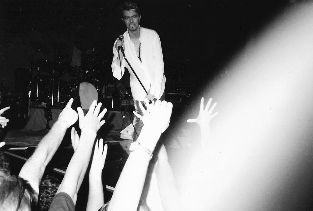 Black and white photo of David Bowie on stage at Birmingham QUE Club