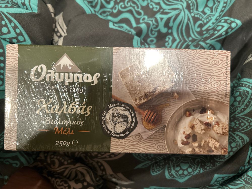 Green and tan food cardboard box. Says Halvas Organic Honey. Established in 1949 but in Greek.