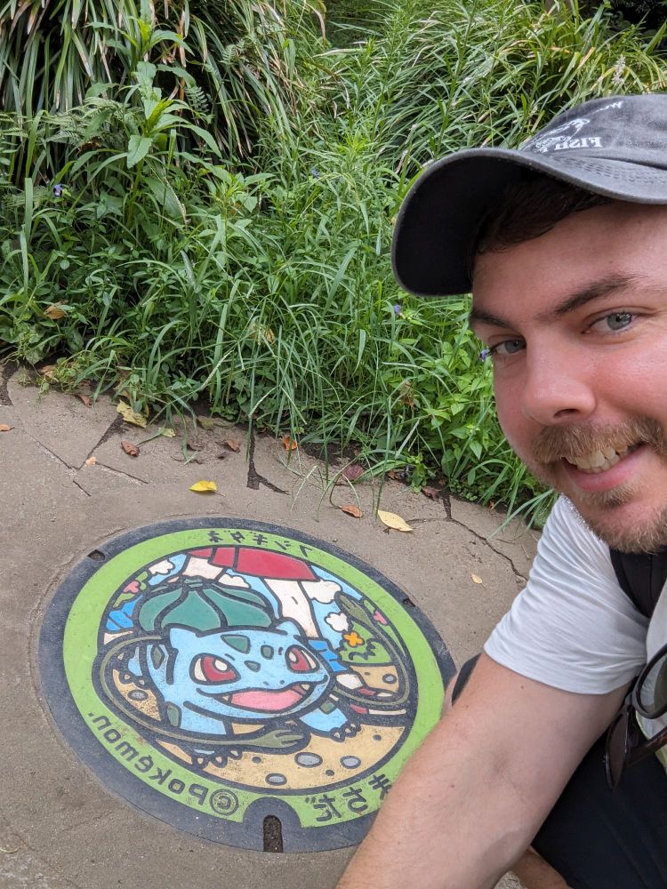 Mr Beast lookin dipshit taking a selfie in front of a Pokelid
