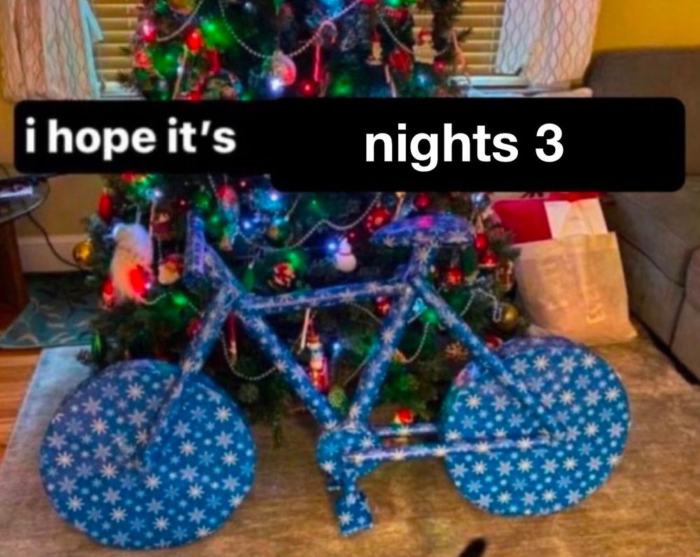 a bike wrapped in wrapping paper with text over it that says “i hope it’s nights 3”