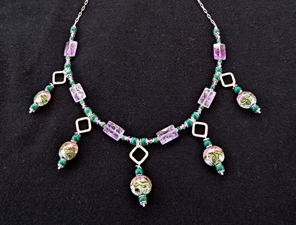 For this week's theme of "alternating", I chose a piece of jewelry I made in 2020 with alternating beads of purple and green colored glass and stones, and silver beads. The dangles alternate between violet glass rectangles on the chain. The flat glass beads on the dangles are handblown, tying together all the colors on the strand. 