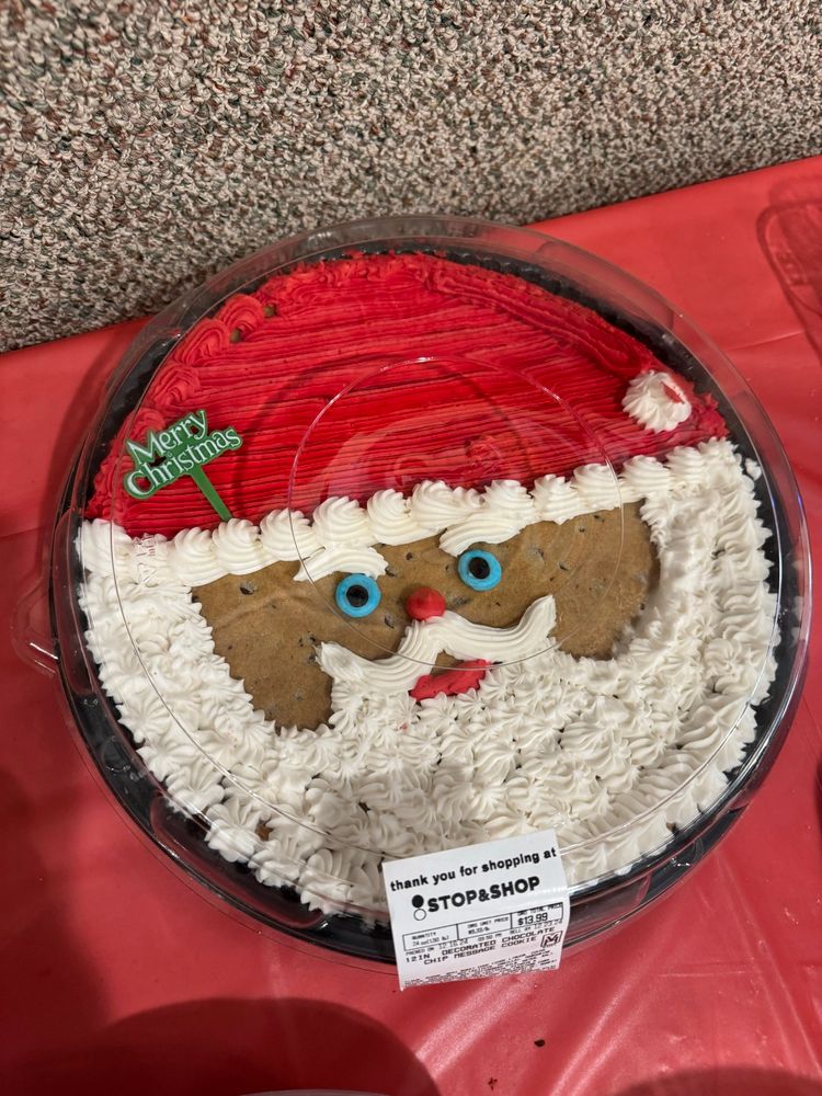 Big ass circular Santa cookie from stop & shop bakery with piercing AF lil green bug eyes