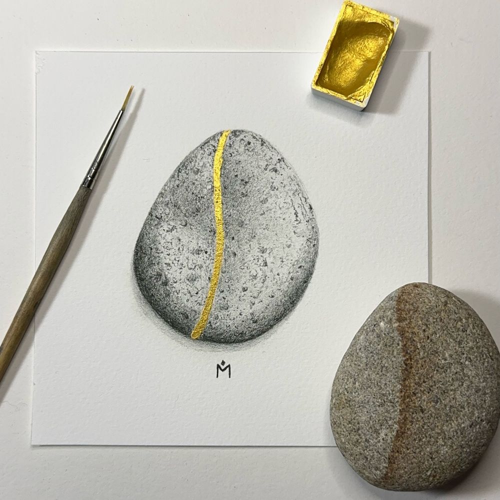 A 5x5 inch print of a stone with gold embellishment