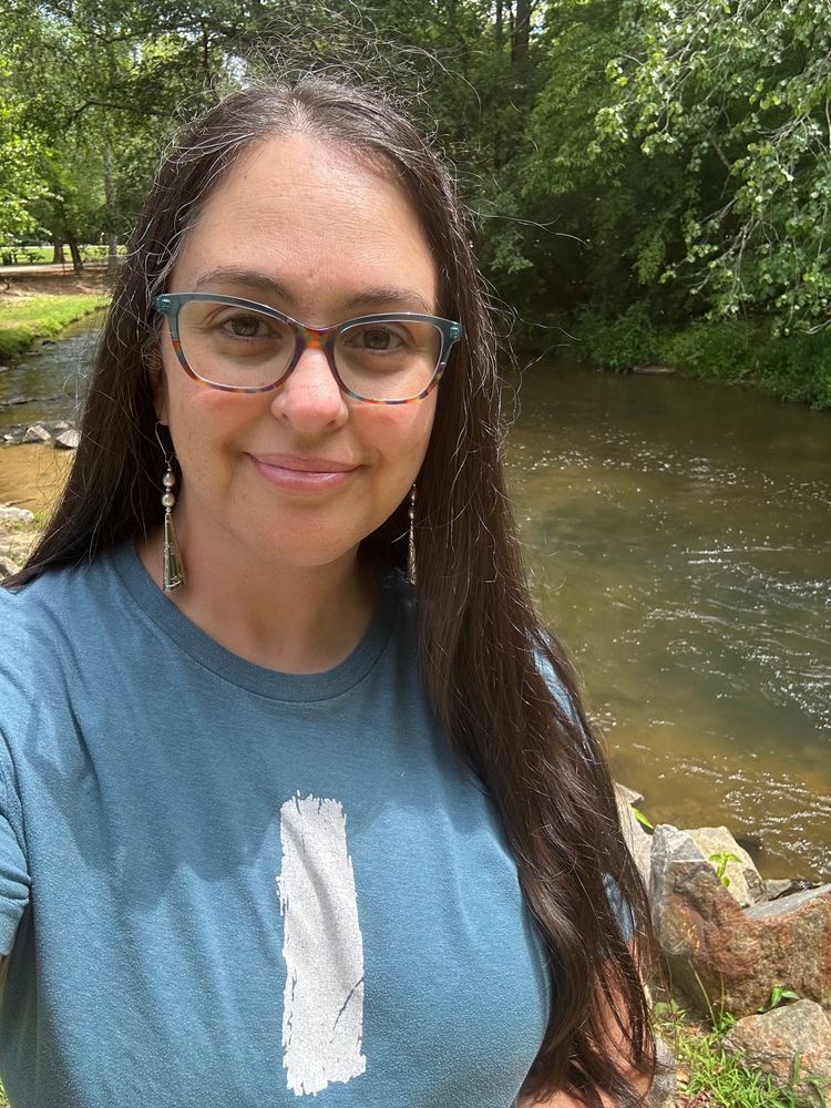 Tired me standing next to a creek