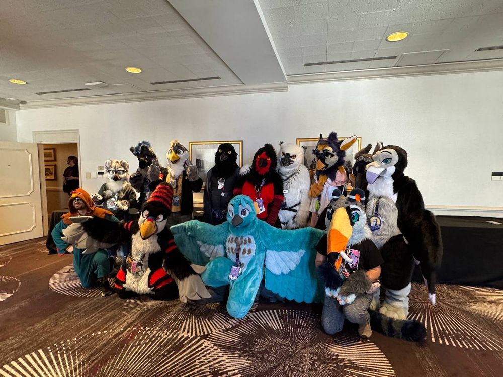 A group of bird fursuiters posing for a photo together.
