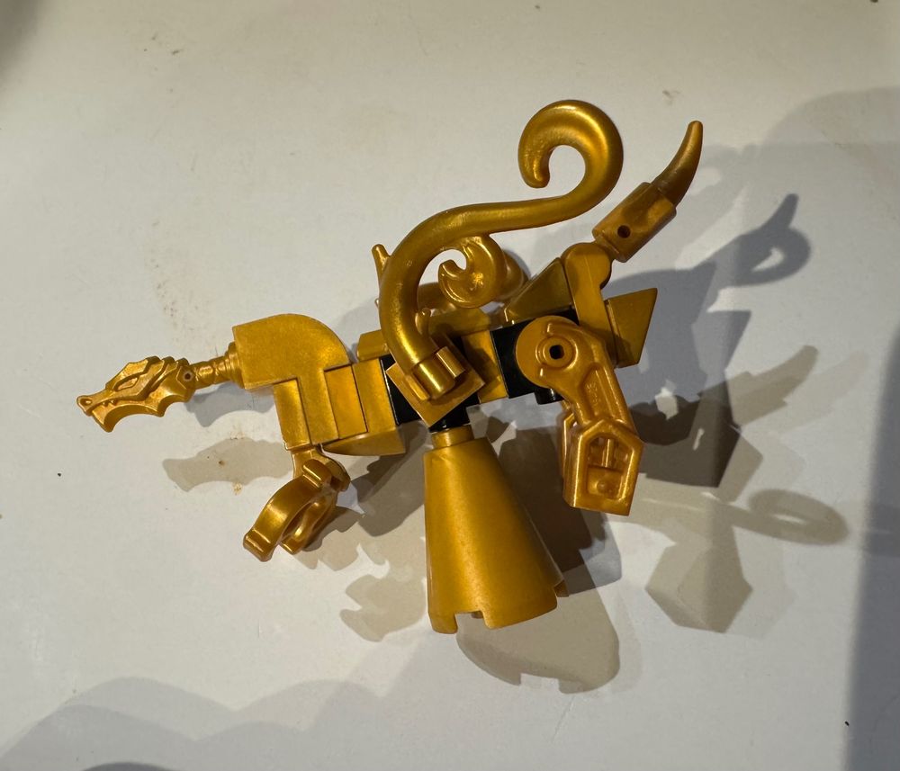 A scratch-built gold lego dragon statue.