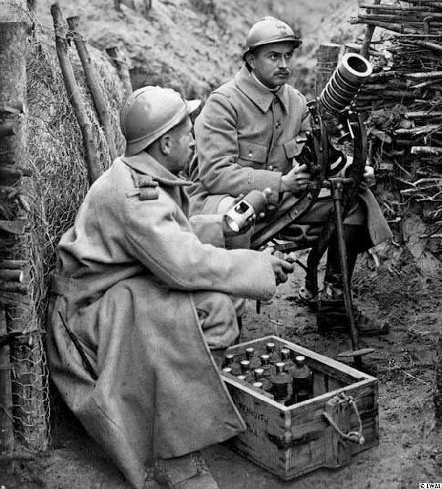 Two French soldiers in a model trench with a grenade launcher. Probably in a training or demonstration area at La Ville-aux-Bois (02) SW of Saint-Dizier. One soldier sits or squats behind the weapon, ready to pull a trigger to fire it, another prepares to hand him a bomb or grenade. There is a box full of these bombs by his feet. 
This weapon is a « lanceur Guidetti ». 






Some users just post the image that they’ve taken from another organisation’s website without giving credit. This account always endeavours to credit the archive that preserves￼ these historical assets￼. 