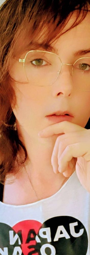 Vertically cropped photo of Carsyn in her gold glasses and white off-shoulder tee