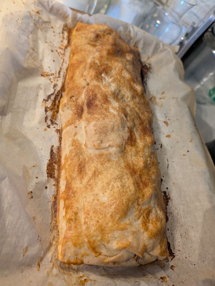Rectangular shaped apple pie on parchment paper. Beautiful golden brown finish due to egg wash.