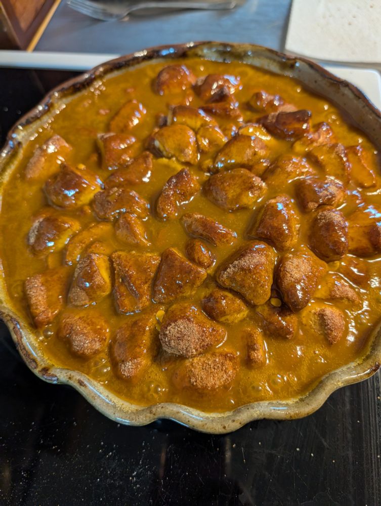 Round pan filled with baked biscuits that were coated in cinnamon sugar and then drowned in butterscotch sauce.
