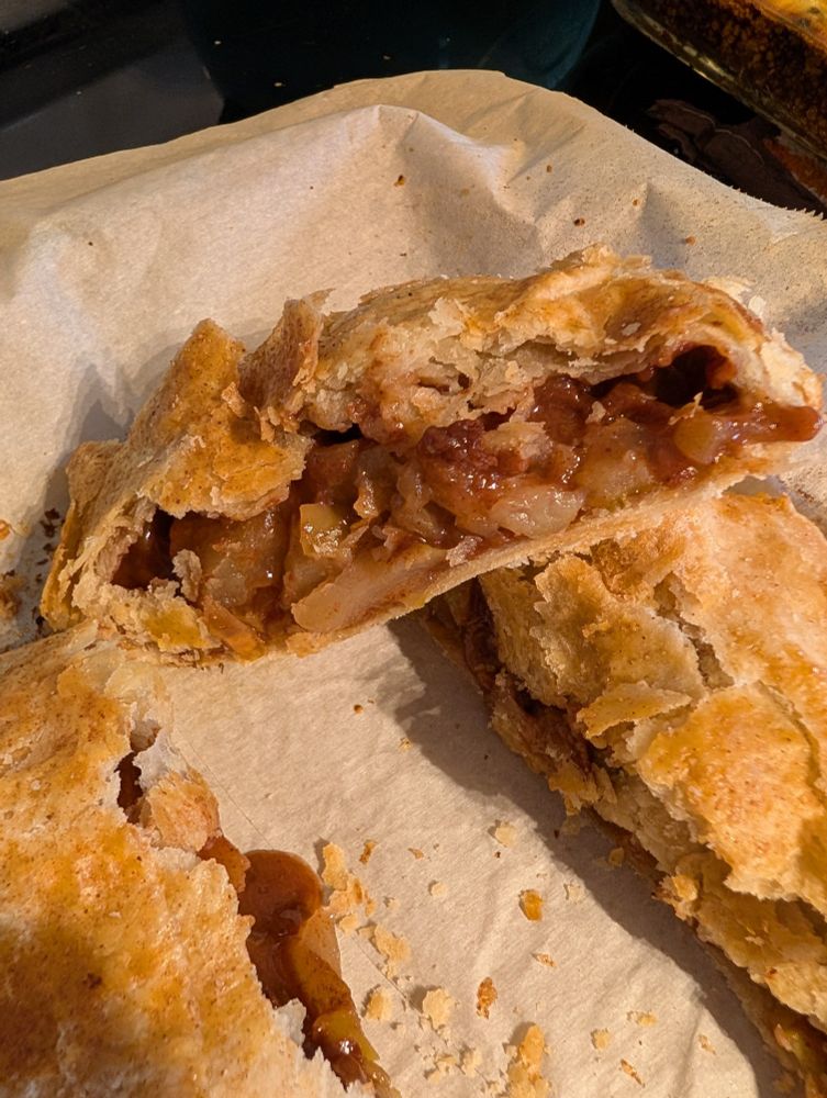 Picture of freeform apple pie slice, highlights the flaky crust and the cinnamon Apple filling.