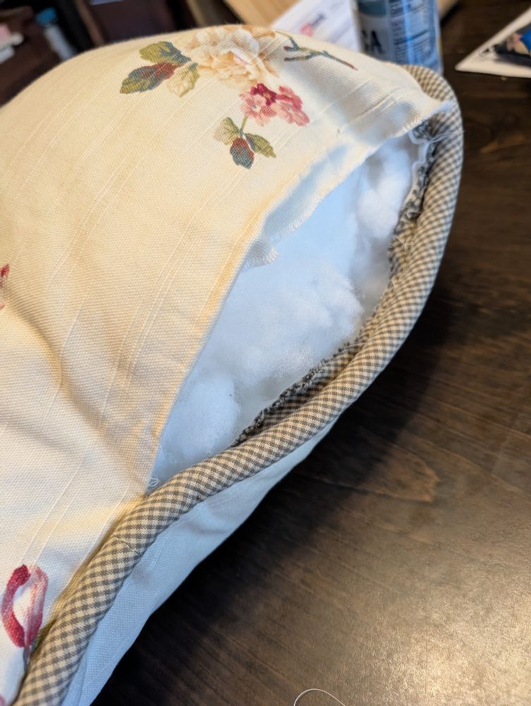 Pillows with stuffing coming out a burst seam.