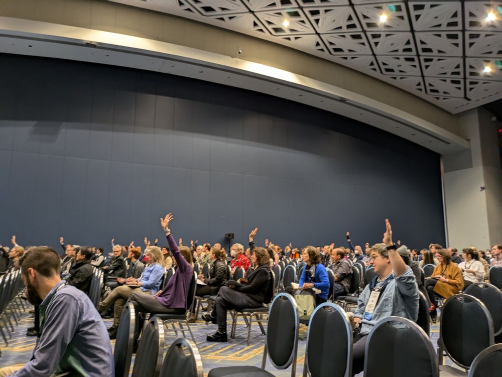 Audiences raising hand during a lecture.