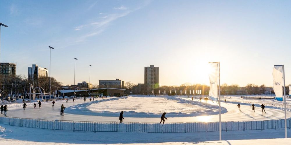 people skating at the Halifax Oval while the sun sets