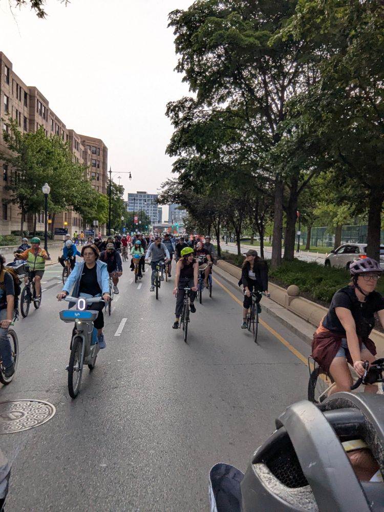 Bicyclists riding in the street for Chicago's Critical Mass. This time the picture is showing faces instead of backs.