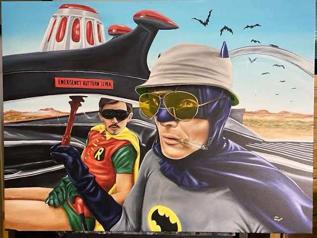 A mashup of of Batman and Robin as they appeared in the 1960s “Batman” TV series riding in the Batmobile and the main characters of Hunter S. Thompson’s “Fear and Loathing in Las Vegas.” Batman wears his blue and grey costume along with a bucket hat and yellow sunglasses and clenches a cigarette holder in his mouth. Robin — in addition to his red, yellow, and green costume with black mask — sports a mustache and soul patch. Behind the Batmobile you can see a vast, open desert with a blue sky, with horrific bats flying through it. Batman is reaching for a red lever labeled “Emergency Bat Turn Lever.” The image is not captioned, but would probably feature the text from “Fear and Loathing”: “We can’t stop here! This is bat country!”